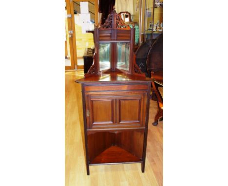 Edwardian cedar corner cabinet fretwork decoration to mirror backed top, over compartment with door. Open shelf to bottom. H1