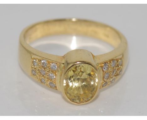 18ct yellow gold and yellow sapphire set ring textured shoulders set with small diamonds, size 6-7/M, total weight 4.9gm.