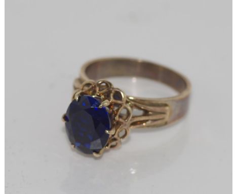 9ct yellow gold & blue stone ring total weight 3.8gms. Stone tests as sapphire, but believe synthetic.