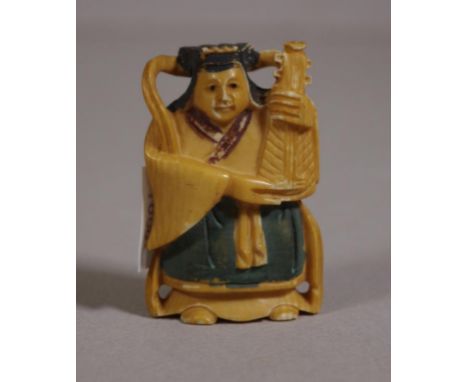 Antique Japanese ivory netsuke depicting a man holding a musical instrument, 5cm high approx. .