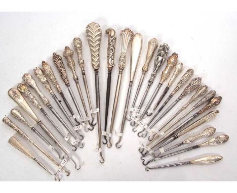 A group of twenty eight late 19th/early 20th Century silver and steel button hooks, various dates and makers, 12-27cm long