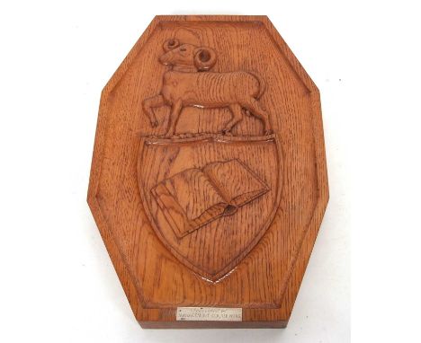 Vintage hand carved presentation oak plaque depicting a ram above a shield and open book, the plaque beneath stamped silver w