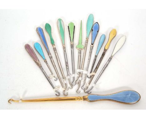 A group of twelve early 20th Century silver, enamel button hooks, various dates and makers together with a silver plated exam