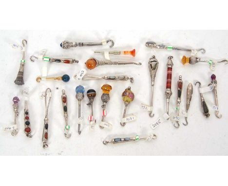 A group of eighteen late 19th/early 20th Century small button hooks, stone set with various dates and makers together with si