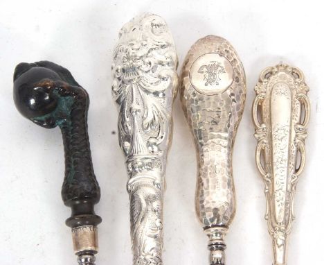 Four late 19th/early 20th Century button hooks, bronze ball and claw handle example with silver ferrel, Sheffield 1889, maker