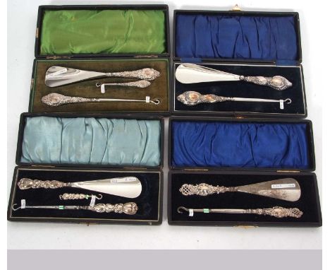 Four cased silver handled button hook and shoe horn sets, Chester 1913, Birmingham 1902/3/5