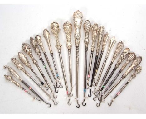 A group of twenty one late 19th/early 20th Century silver and steel button hooks of various dates/makers, 12-28cm long