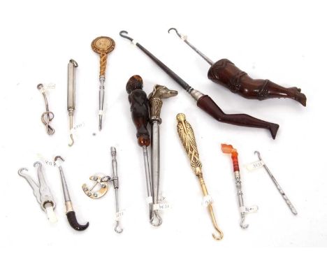 Group of novelty button hooks including a carved horn jockey handle, a cast metal greyhound, two treen shoe and leg examples,