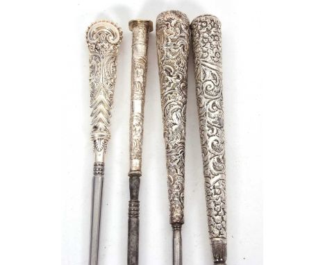 Group of four Victorian long handled button hooks, two with hallmarked walking stick/cane design handles, embossed and chased