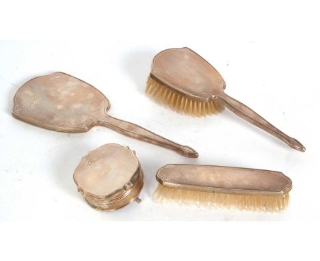 Four pieces of dressing table wares to include a hand mirror, ring box, clothes and hair brush, each with engine turned decor