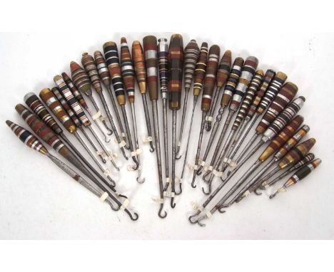 Group of thirty two trench art mixed metal banded button hooks, 7-22cm long