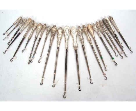 A group of twenty two late 19th/early 20th Century silver and steel button hooks, various dates/makers, 13-28cm