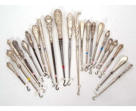 A group of twenty two late 19th/early 20th Century silver and steel button hooks, various dates/makers, 11-28cm long