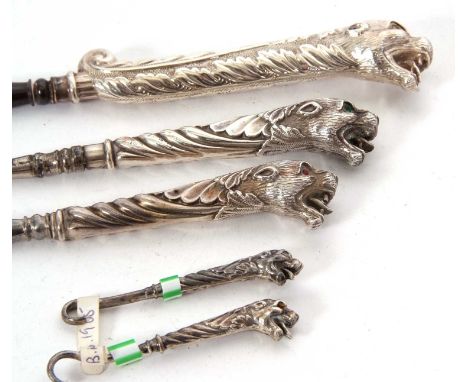Group of five silver handled and steel button hooks, the handles modelled as leopards head, the three large examples with ope