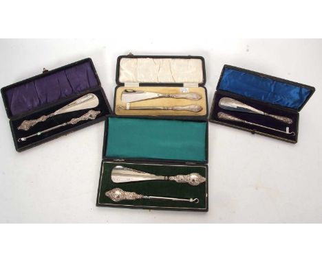 Four cased silver handled matching shoe horn and button hooks, Birmingham 1892, 1905, 1913 and 1922