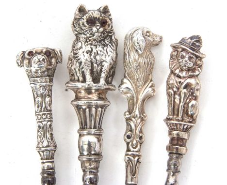 Four Edwardian silver and steel novelty button hooks, three dogs and one cat example, hallmarked for 1901/06/09 and 1910, Chr