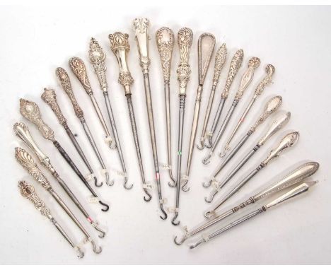 A group of twenty two late 19th/early 20th Century silver and steel button hooks, various dates/makers, 12-29cm long