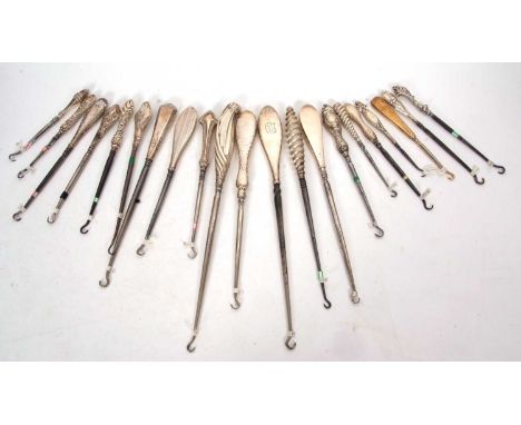 A group of twenty one late 19th/early 20th Century silver handled button hooks, various dates/makers, 12-28cm long