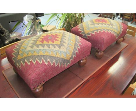 STOOLS, a pair, vintage kelim upholstery, on raised polished turned wooden supports, 52cm L x 37cm W. (2)