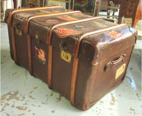 TRUNK, early 20th century canvas with a rising top decorated with various hotel labels and an interior tray, 95cm W x 50cm H 