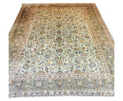 FINE KASHAN CARPET, 380cm x 283cm, all over palmette and vine design on a jade field within corresponding bands and borders.