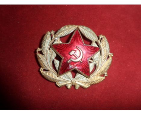 Badge Russia - Communist era officers cap badge. Gilt and red enamel, wire fittings. Red enamel star, hammer & sickle mounted