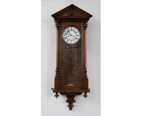 A mahogany cased Vienna style wall clock with two train movement, with pendulum and weights.