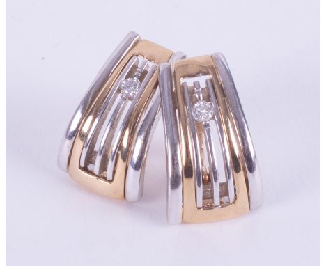 A pair of 9ct yellow &amp; white gold curved design stud earrings set with approx. 0.14 carats total weight of round brillian