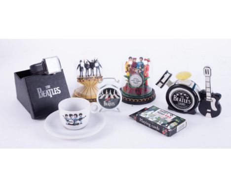 Small collection of Beatles memorabilia including a stainless steel wristwatch, small alarm clock, cup and saucer etc.