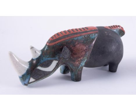 A ceramic art pottery model of a rhino, impress porcupine, length 29cm.