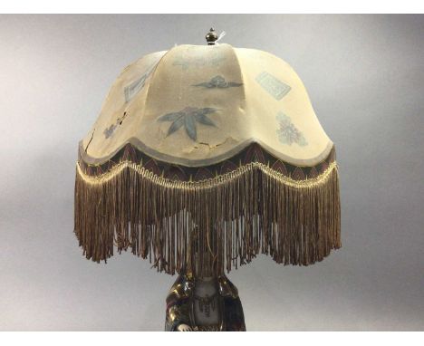 JAPANESE CERAMIC BUDDHA TABLE LAMP,with a distressed fringed silk shade, 60cm high overall