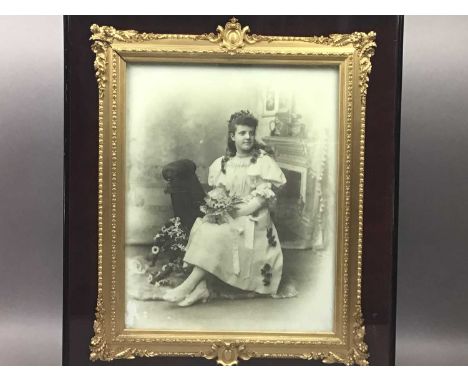 LATE VICTORIAN PORTRAIT PHOTOGRAPH,depicting a seated girl, on opaque glass, in a gilt gesso frame, mounted within velour and
