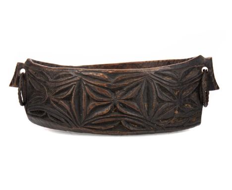 EARLY MELANESIAN TRIBAL CARVED WOODEN CEREMONIAL BOWL,likely Papua New Guinea, of 'canoe' form with twin iron ring handles an