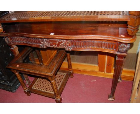 A reproduction hardwood serpentine front console table, in the Classical taste, w.127cm