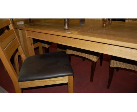 A contemporary light oak rectangular dining table having a planked and cleated top, length 150cm