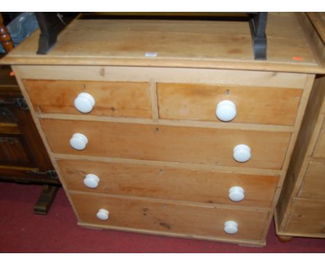 A Victorian pine squarefront chest of two short over three long drawers, with white glazed ceramic knob handles, w.95cm
