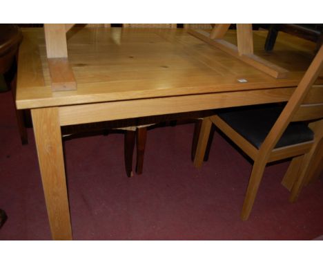 A contemporary light oak rectangular dining table having a planked and cleated top, length 150cm