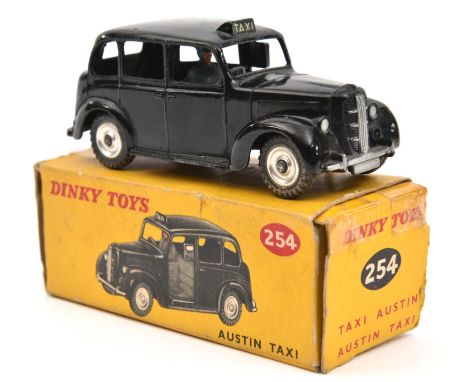 Dinky Toys Austin Taxi (254). Late example in black with spun wheels and dark grey base. Boxed, some wear/damage. Vehicle VGC