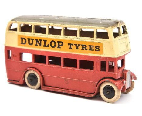 A rare 1930's Dinky Toys Double Decker Bus (29c). An example with cream upper and red lower body, with dark grey roof and Dun