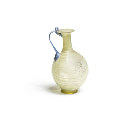  A Roman pale green glass jug with blue looped handle Circa late 1st Century A.D.The spherical body decorated with applied li