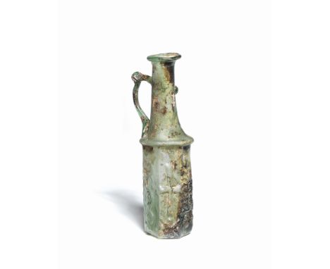  A Byzantine green glass hexagonal pitcher with Christian symbols Circa 5th-6th Century A.D.Blown into a six-sided two-part m
