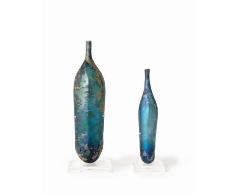  Two Islamic cobalt blue glass bottles Circa 9th-10th Century A.D.Both of elongated cylindrical form, with rounded base, tape