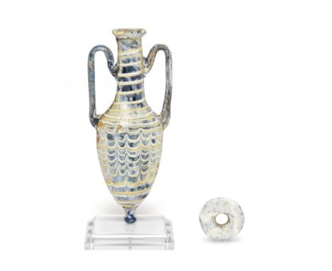  An Eastern Mediterranean core-formed blue glass amphoriskos Hellenistic Period, circa 2nd-mid 1st Century B.C.The piriform b