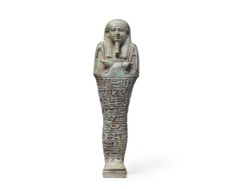  An Egyptian turquoise glazed composition shabti for Heneb-Heneb Late Period, 26th Dynasty, circa 600-550 B.C.The mummiform f