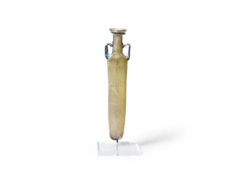  A Roman amber glass flask Circa 3rd-4th Century A.D.The elongated mould blown body with slender vertical ribs and rounded in