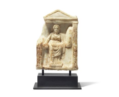  A small Greek marble naiskos with Cybele Circa 4th Century B.C.In the form of a rectangular naiskos with an unadorned pedime