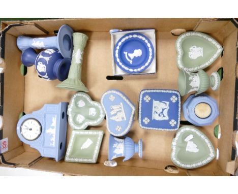A collection of Wedgwood Jasperware to include Dancing Hours candlesticks, mantle clock, pin dishes, lidded boxes, tea light 