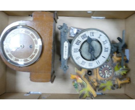 A Collection of Three Clocks to include one cuckoo clock and one art deco mantle clock with bakelite numbers. For spares and 