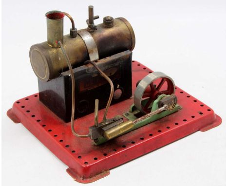 A Mamod miniature live steam plant comprising of a horizontal tin housed boiler powering a single cylinder engine with miniat