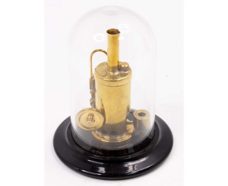 A miniature kit built model of a spirit fired single cylinder vertical steam engine, height 9cm, and housed in a glass displa